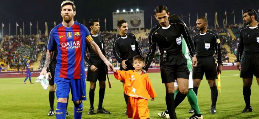 Boy from Afghanistan walks in the stadium with Messi